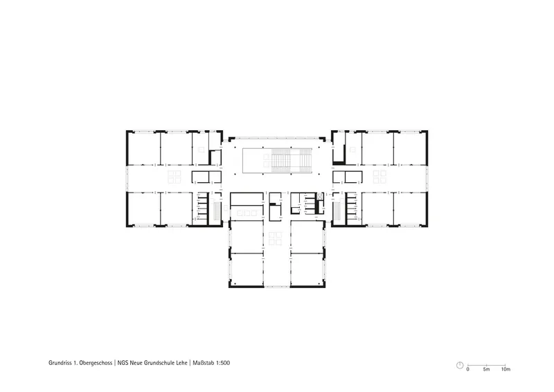 Upper floor plan drawing showing a symmetrical wing layout with central stair and service cores