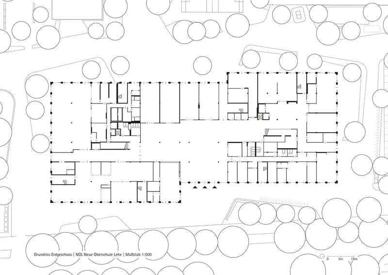 Floor plan drawing showing an L-shaped building with central open spaces and perimeter rooms
