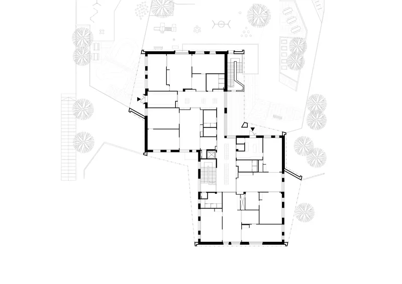 Floor plan drawing depicting apartments radiating from two staircases with landscaping indicated around the perimeter