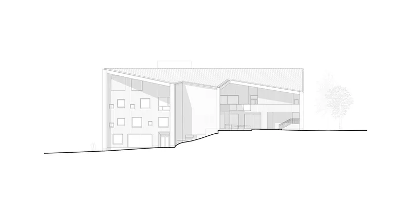 Section drawing revealing sloped rooflines over interior volumes with scattered window openings and a staircase