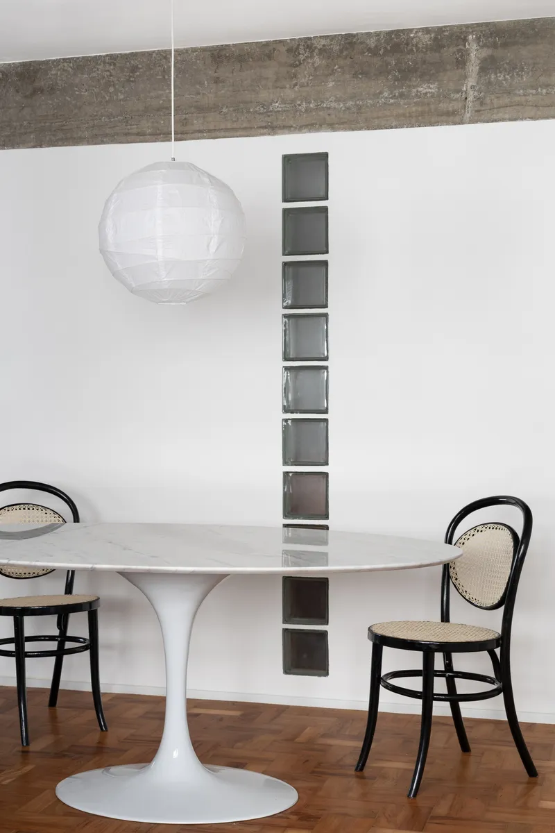 Close-up of the vertical glass block window detail above the white dining table
