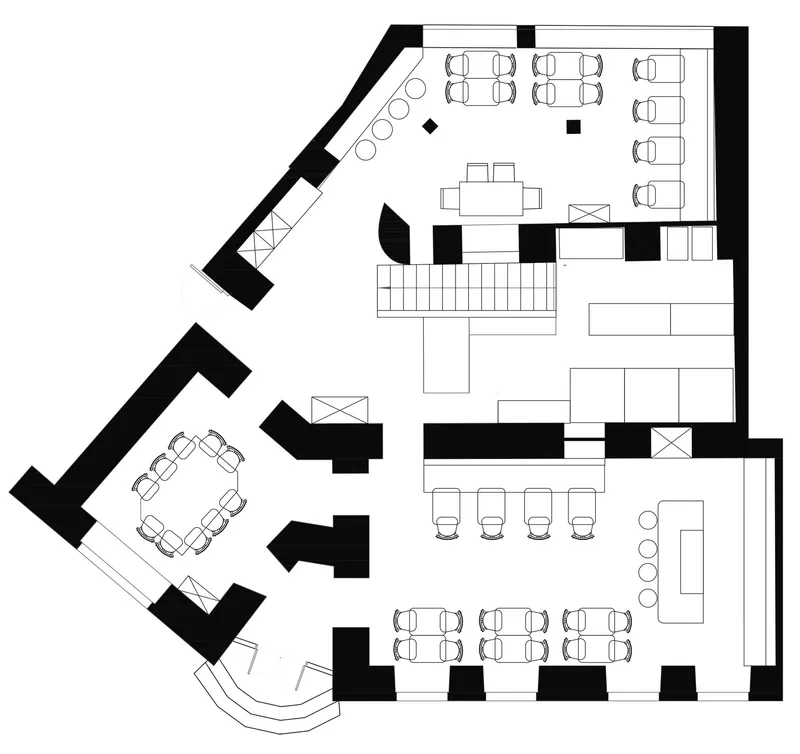 Floor plan drawing showing dining areas with booth and table seating arranged around a central staircase