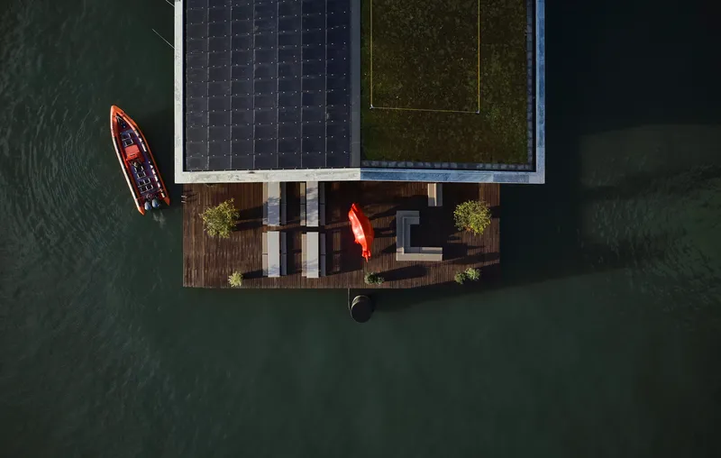 Drone view of the solar panel roof and timber deck with kayaks moored alongside