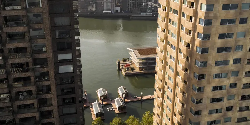Aerial view of the floating pavilions moored between residential towers in the waterway