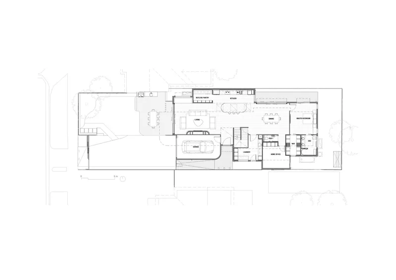 Ground floor plan drawing showing open living spaces with a central staircase and kitchen along the side
