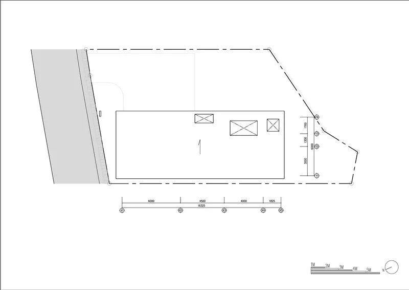 Site plan drawing showing a rectangular building volume with adjacent angled roadway and service areas