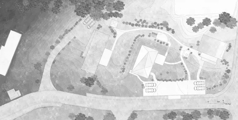 Site plan drawing showing buildings and tree placement along curved access road