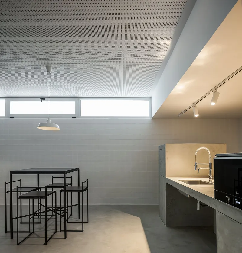 Perforated ceiling and soft lighting enhance acoustic and spatial quality
