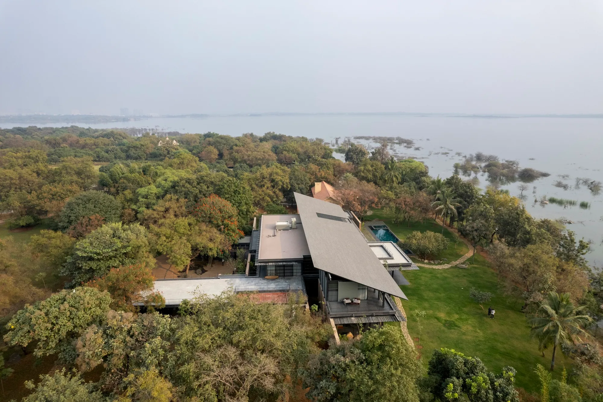 SPASM Design Architects Weave a Steel-and-Earth Lakehouse into 50 Acres of Hyderabad Forest