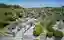 This architectural image showcases a cemetery with a modern, minimalist memorial structure. The memo