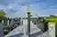 This architectural image showcases a modern memorial site within a cemetery. The design features a c