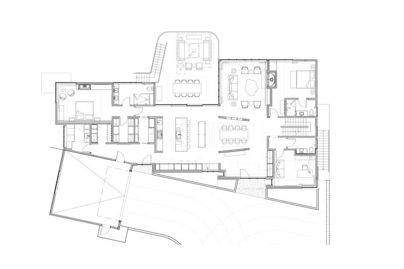 Floor plan drawing showing an irregular layout with angled garage volume and open living areas
