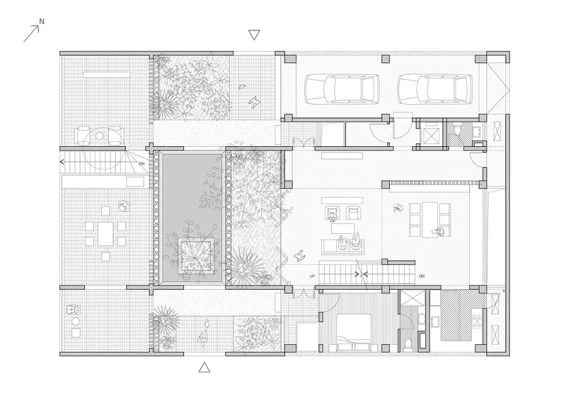 Ground floor plan showing living spaces organized around two internal courtyards with planted gardens