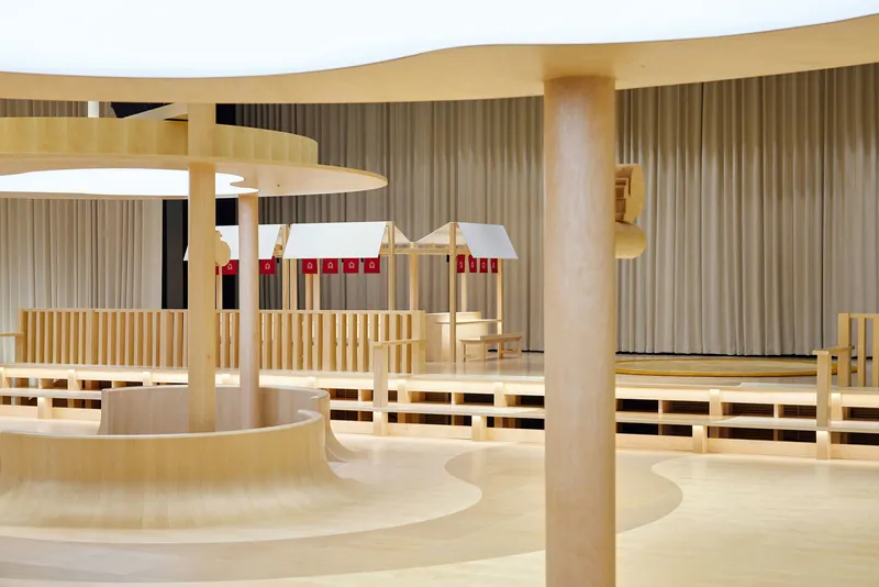 Seating area with horizontal timber slat screens and white pendant lamps with red accent bands