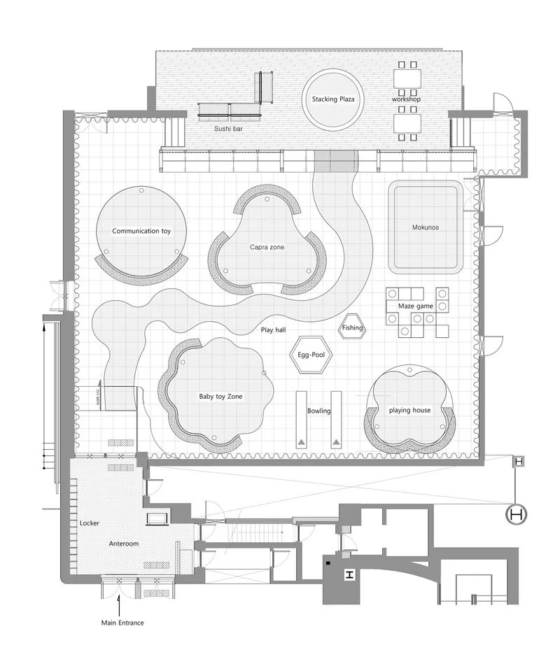 Floor plan drawing showing curvilinear play zones and activity areas radiating from a central hall