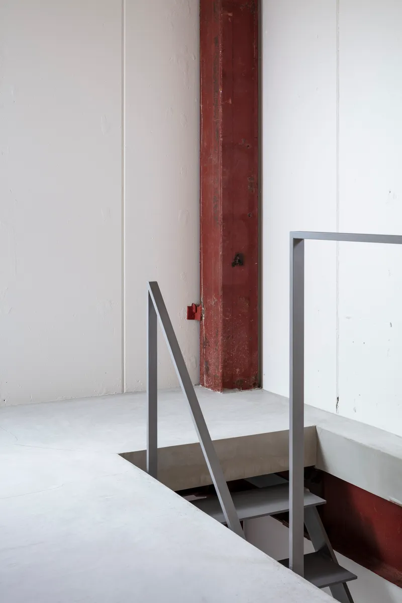 Detail of a steel handrail around a floor opening with an exposed timber column
