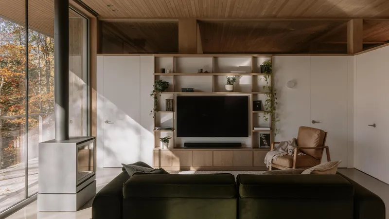 Living room with wood-slat ceiling and built-in shelving in afternoon light