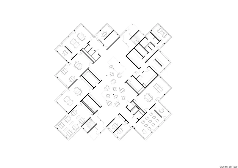 Floor plan drawing showing four protruding wings arranged around a central communal space with furniture indicated