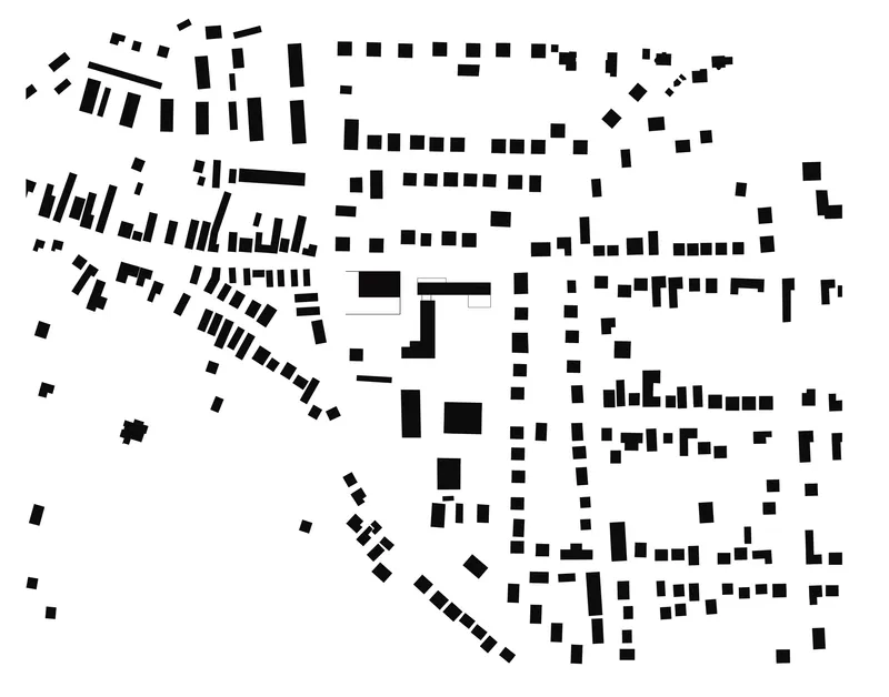 Site plan drawing showing building footprints dispersed across an urban block with diagonal streets