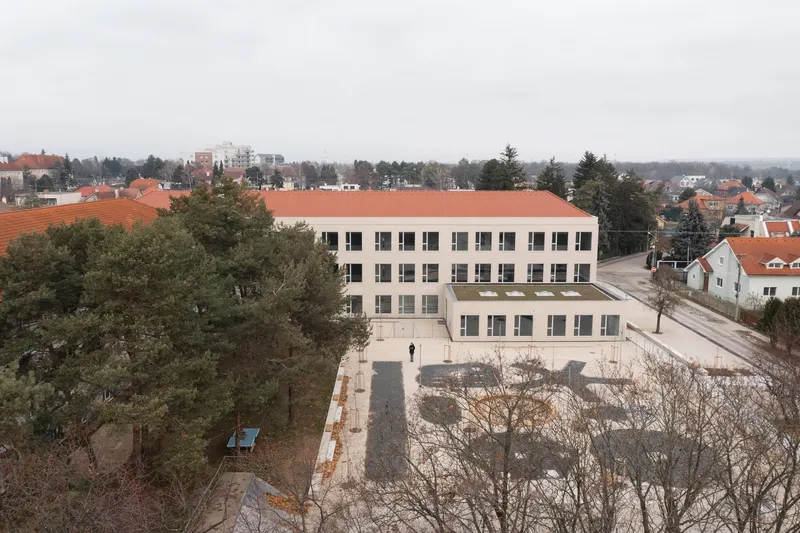 Aerial view of the terracotta tile roof and courtyard surrounded by neighbourhood rooftops