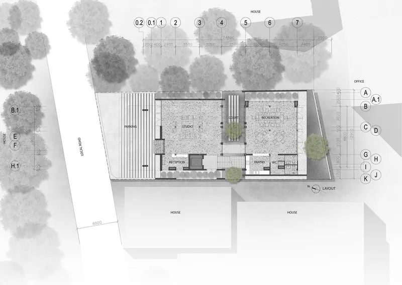 Site plan drawing showing building footprint with central courtyard and surrounding trees