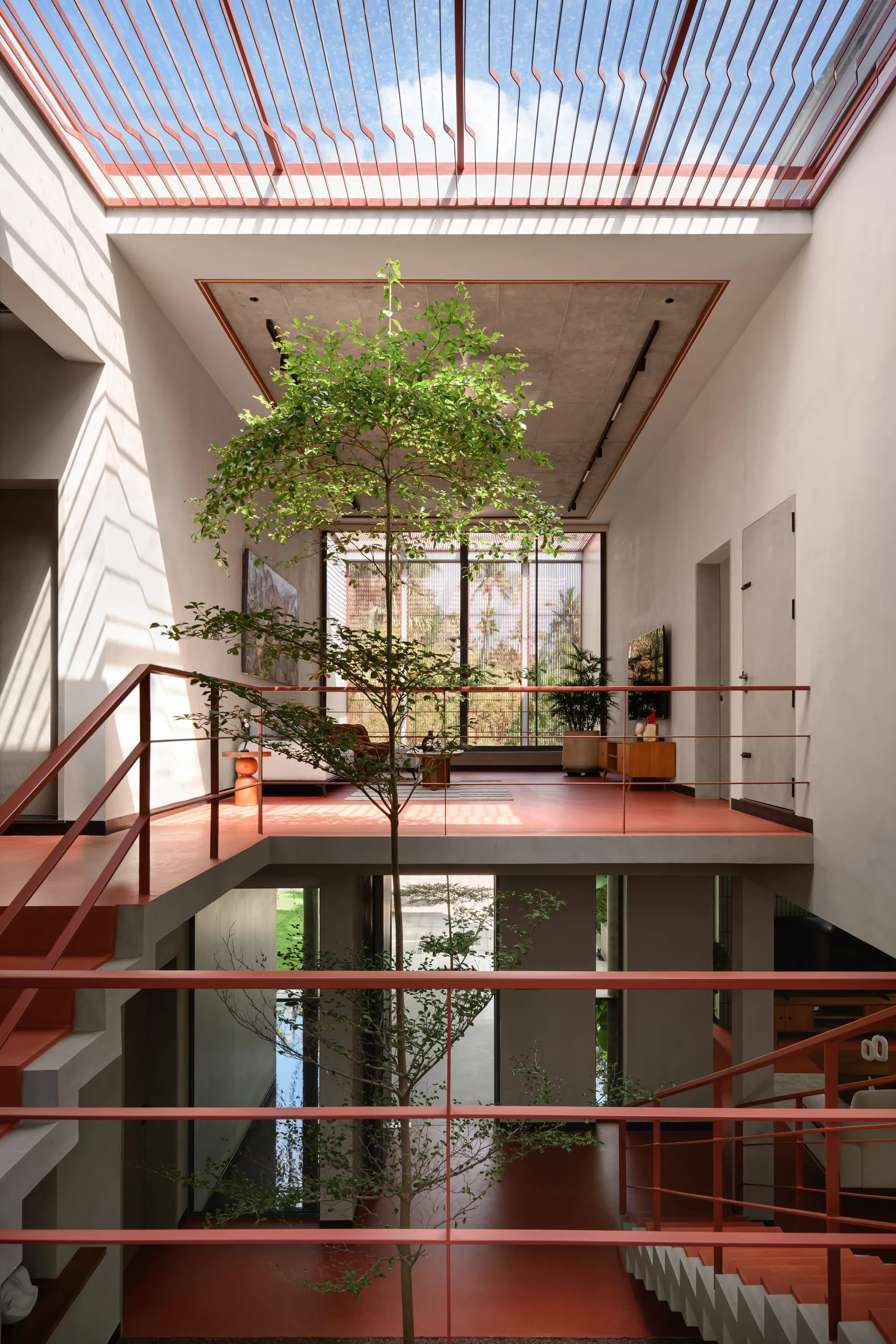 i2a Architects Studio Builds a Bold Red Dream House Around Trees in Kerala