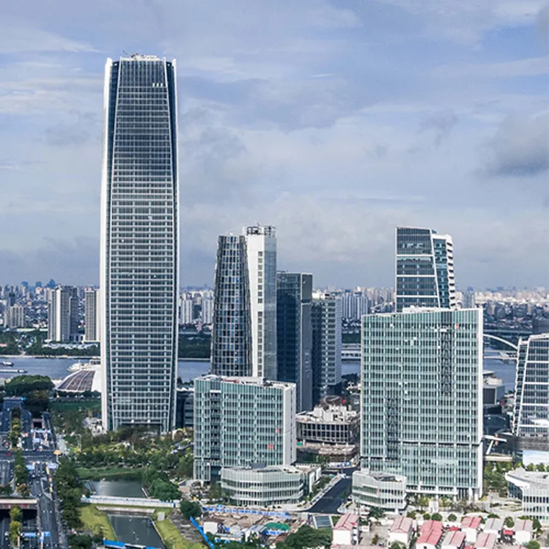 Skyline view of high-rise office towers with curtain wall facades and a distant river