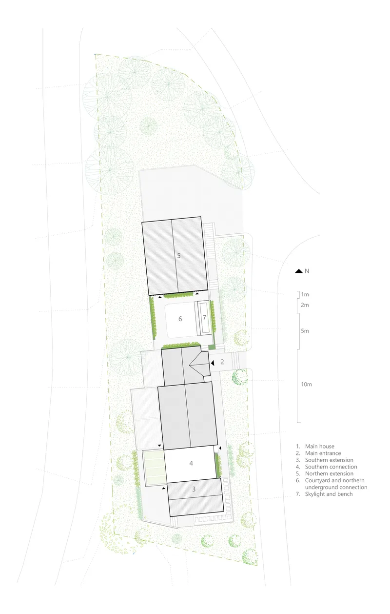 Site plan drawing showing three volumes connected by courtyards and surrounded by landscaping