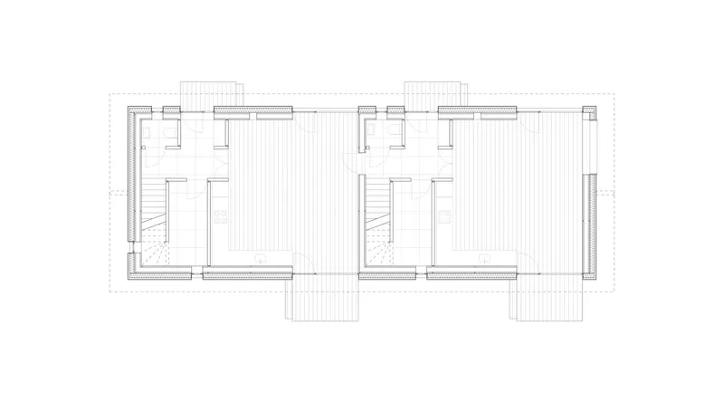 Floor plan drawing showing two mirrored units with staircases and bathrooms flanking a central circulation zone