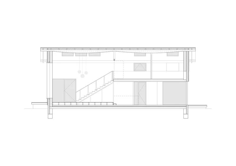 Section drawing showing a two-story interior with staircase, storage below, and upper mezzanine level