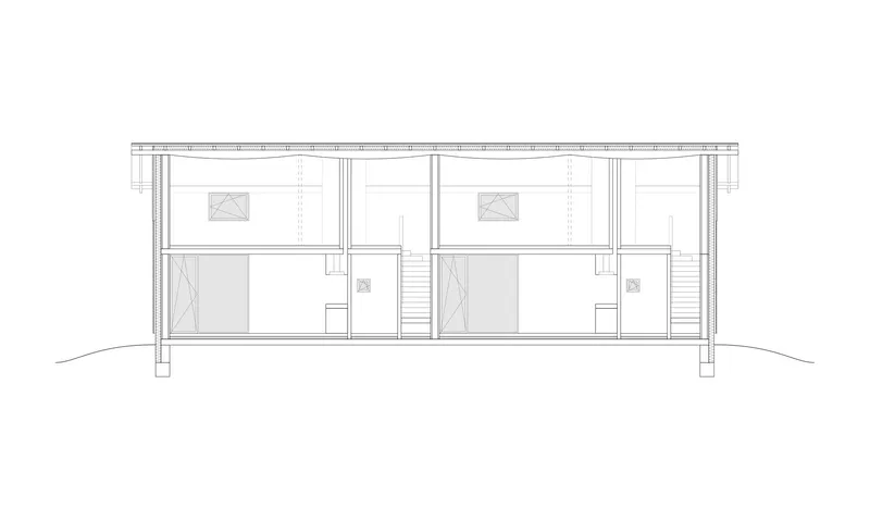 Section drawing showing two adjoining two-story units with central staircase and upper sleeping areas