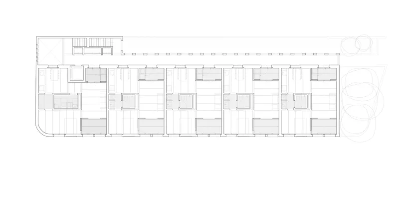 Floor plan drawing showing a linear arrangement of five residential units with a shared corridor and stairs