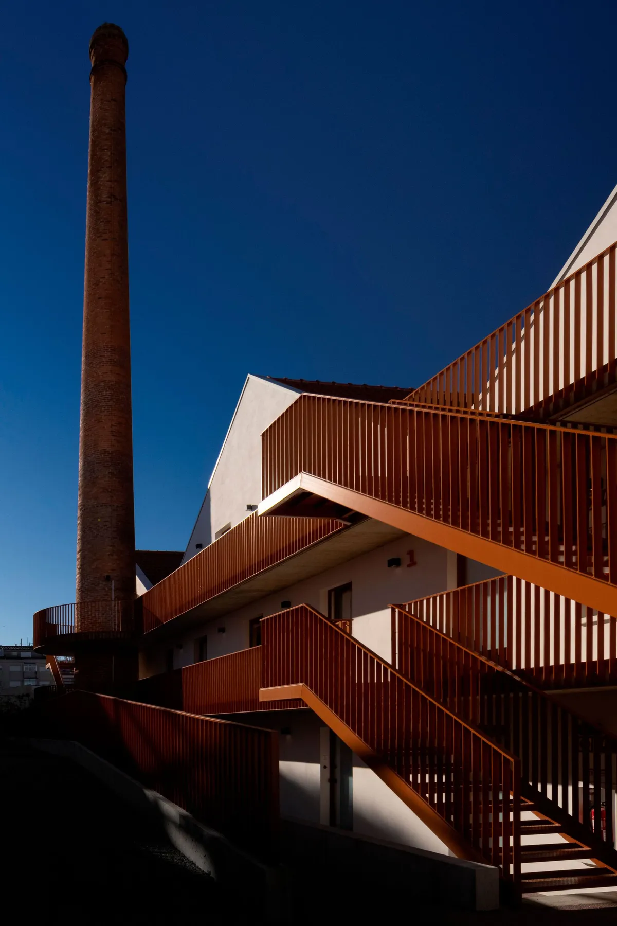 Fragmentos Converts a Porto Factory into a Housing Complex Anchored by Its Own Chimney