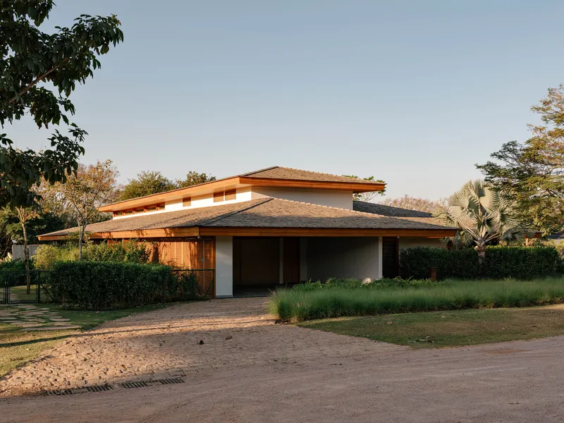 Street view of the layered timber roof with wide eaves at golden hour