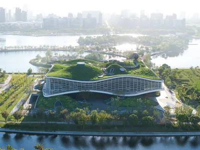 Scenic Architecture Office Sculpts a Science Fiction Museum from Concrete Waves on a Shanghai Lake