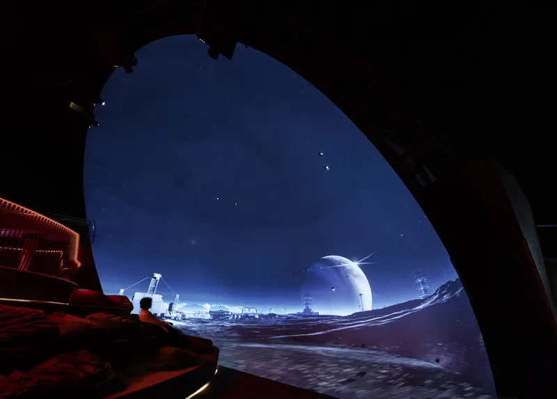 Curved opening framing a projected lunar landscape with illuminated dome structures and distant peaks