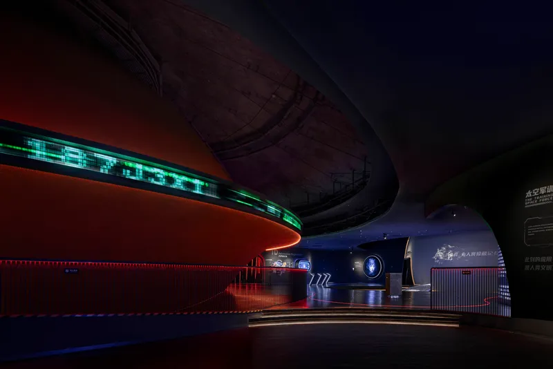 Exhibition gallery with curved soffit, LED data displays, and red horizontal light bands
