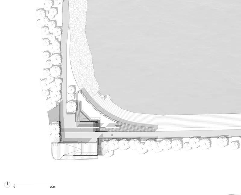 Plan drawing showing a curving roof structure meeting a wooded landscape with interior support elements