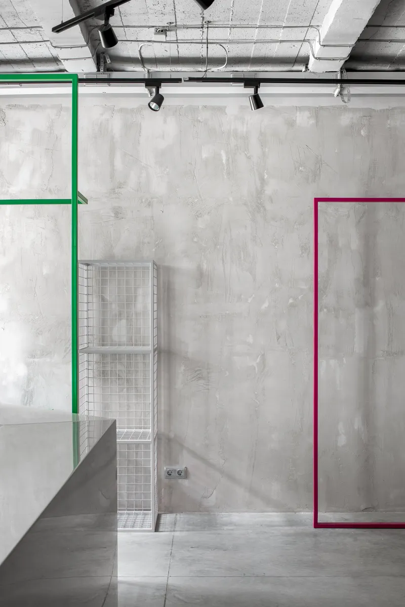 Flexible exhibition system with colored frames defining adaptable retail zones.