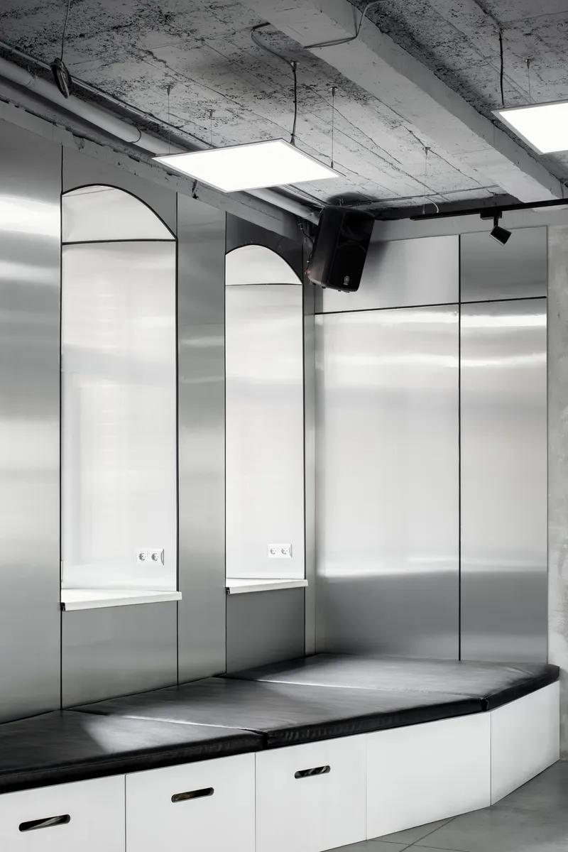 Industrial ceiling with track lighting enabling adjustable exhibition illumination.
