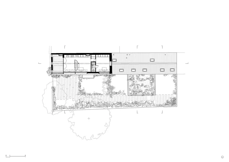 Upper floor plan drawing showing bedroom spaces and a large covered terrace with skylights