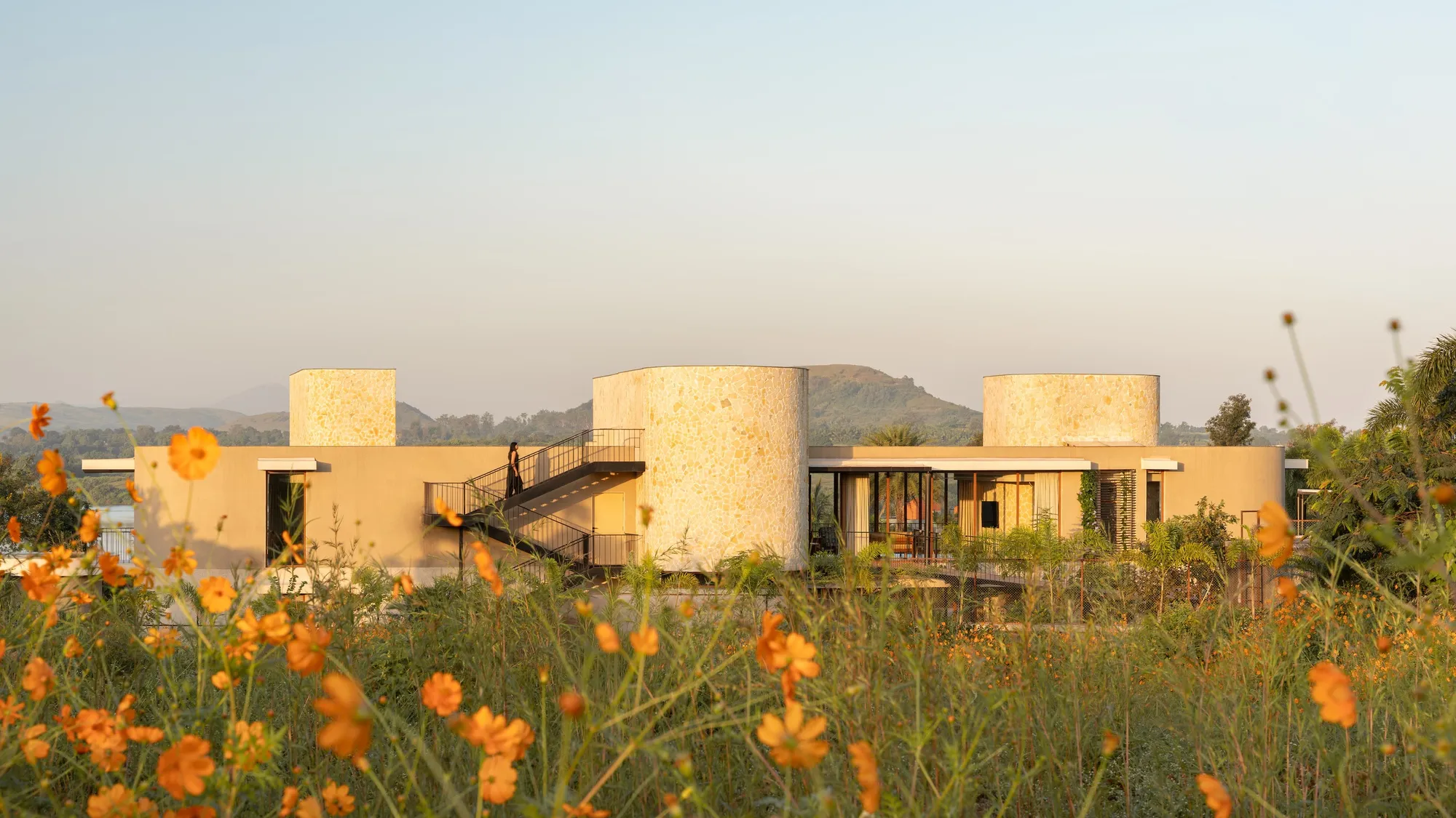 Atelier Landschaft Wraps a Lakeside Micro-Resort in Stone Cylinders at the Edge of an Indian Dam