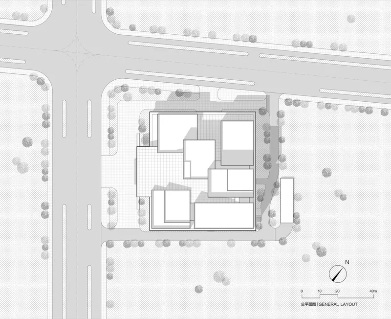 Site plan drawing depicting clustered rectangular volumes surrounded by perimeter trees and adjacent roadways