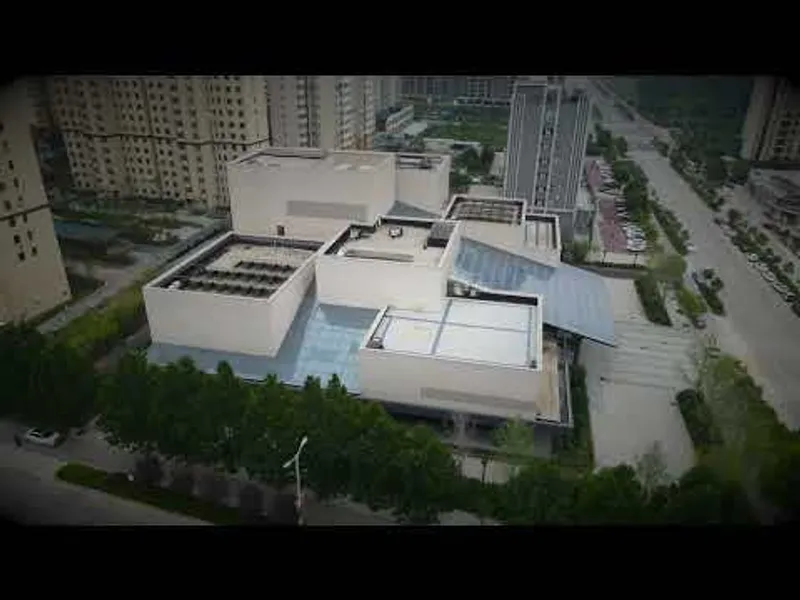 Aerial view of the white cubic volumes arranged around central courtyards within an urban residential district