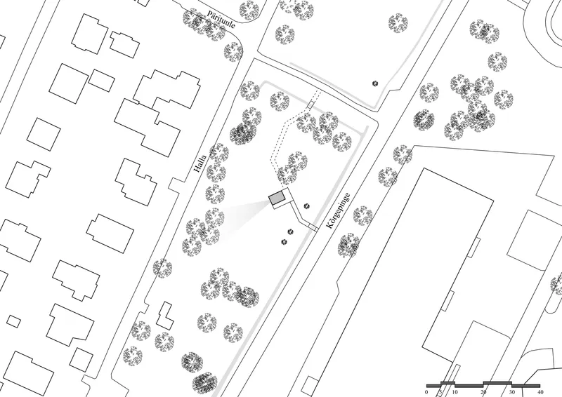 Site plan drawing showing a rectangular structure surrounded by trees and adjacent buildings