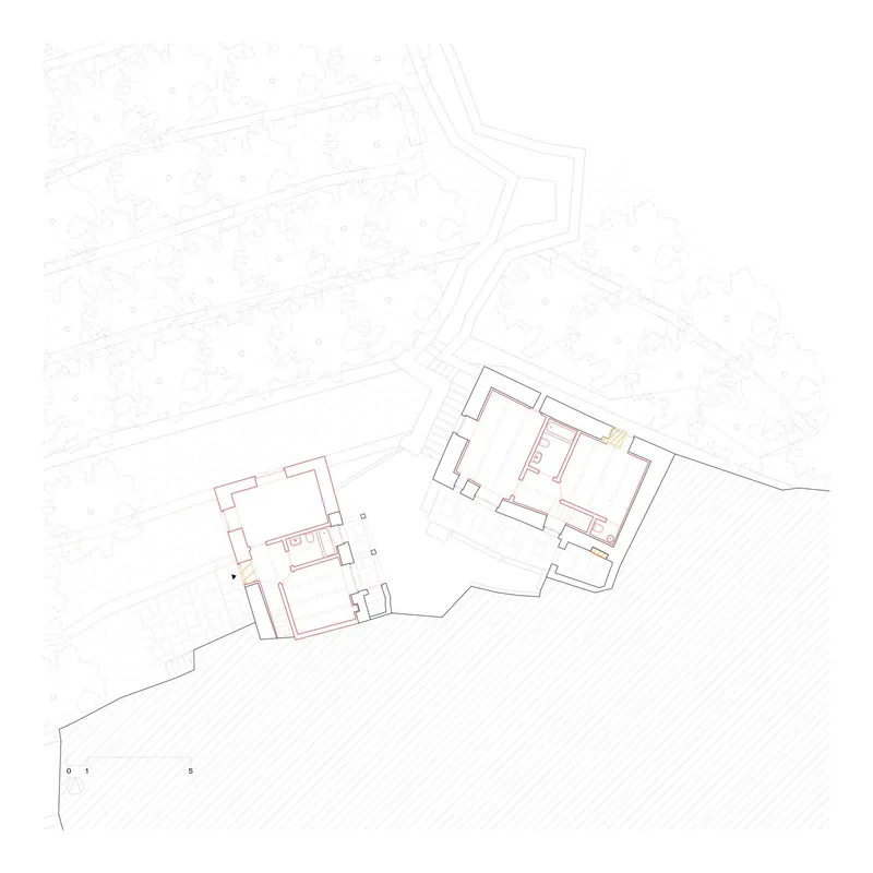 Floor plan drawing showing two adjacent structures with highlighted circulation path on sloped terrain