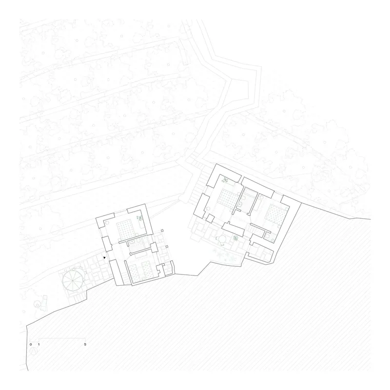 Floor plan drawing revealing interior room layouts and wall thicknesses of two connected structures