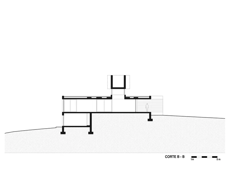 Section drawing revealing two-story interior volumes with central tower and terraced exterior deck on sloped terrain