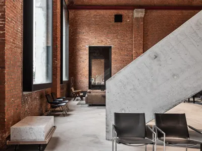 Objekt Architecten Pours a Concrete Disc Through an Aalst Weaving Mill Turned Showroom