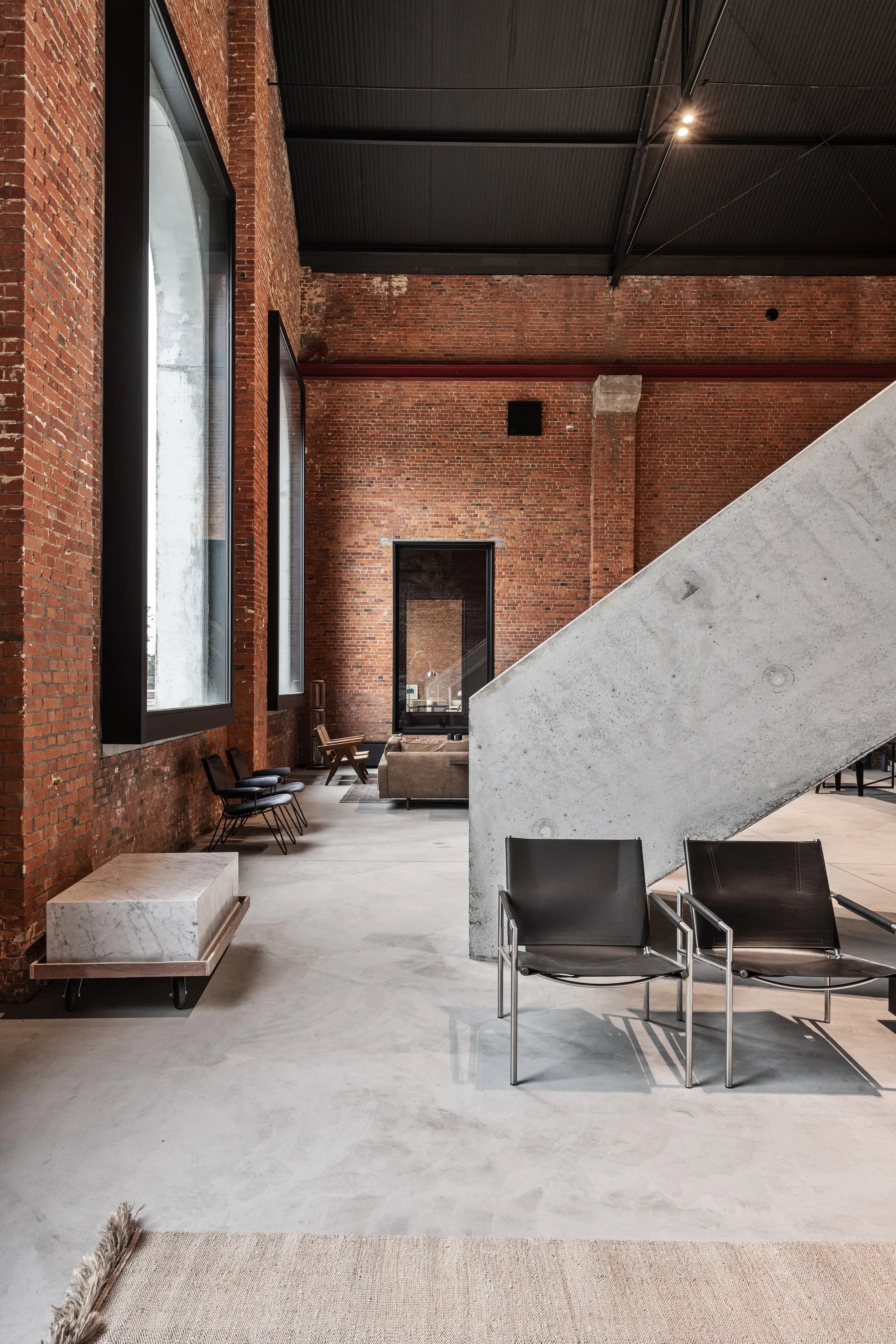 Objekt Architecten Pours a Concrete Disc Through an Aalst Weaving Mill Turned Showroom